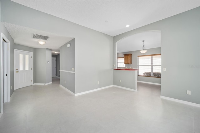 unfurnished room featuring a textured ceiling