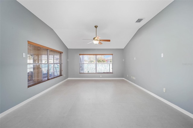 tiled empty room featuring ceiling fan and vaulted ceiling