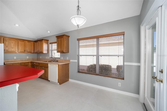 kitchen featuring vaulted ceiling, pendant lighting, sink, white appliances, and light tile patterned floors