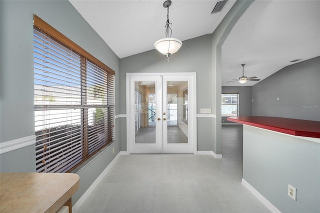 doorway to outside featuring ceiling fan, french doors, vaulted ceiling, and a textured ceiling