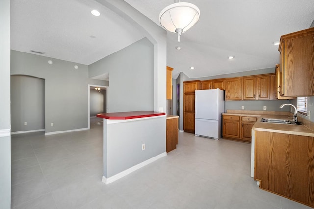 kitchen with sink and white refrigerator