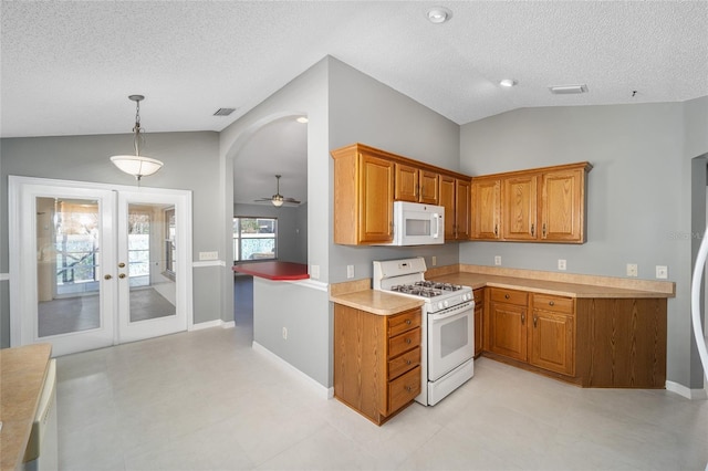 kitchen with ceiling fan, vaulted ceiling, pendant lighting, white appliances, and french doors