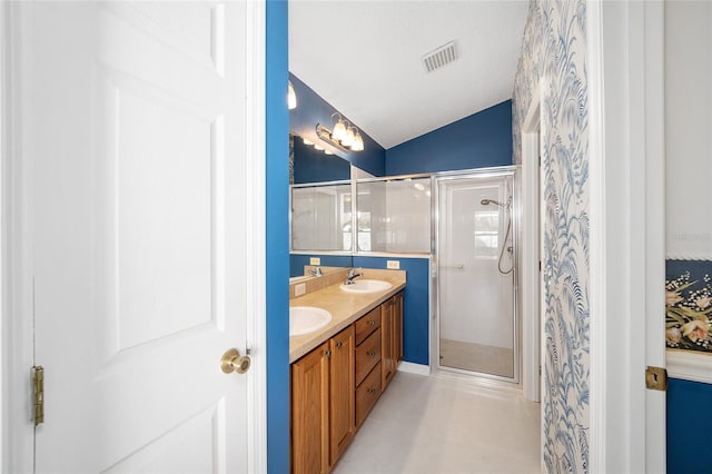 bathroom featuring walk in shower, vanity, vaulted ceiling, and a textured ceiling