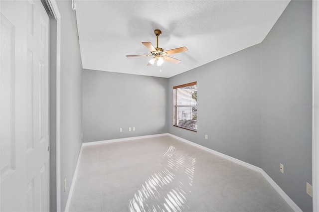 empty room featuring ceiling fan and a textured ceiling