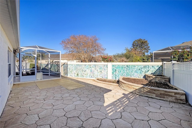 view of swimming pool featuring a lanai and a patio