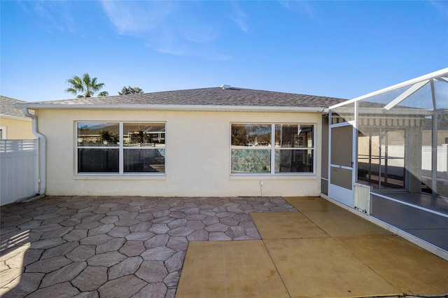 back of house featuring a lanai and a patio