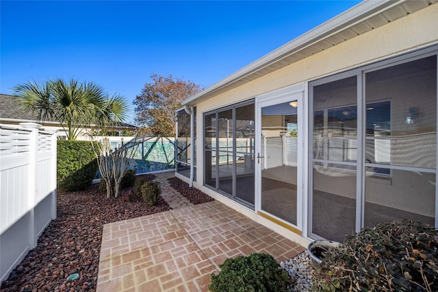 view of patio featuring a sunroom