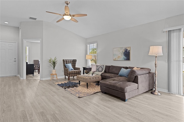 living room with ceiling fan, lofted ceiling, and light wood-type flooring