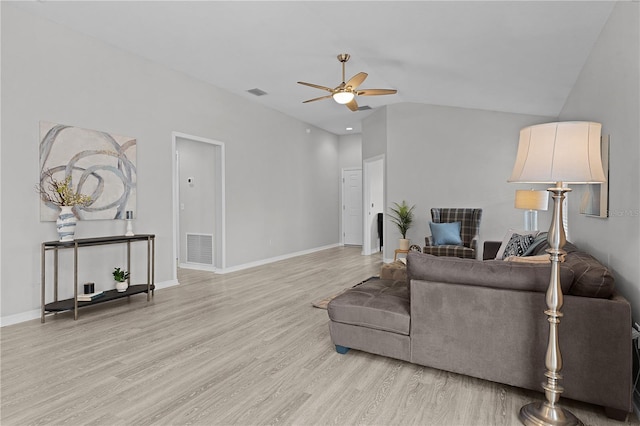 living room with ceiling fan, lofted ceiling, and light hardwood / wood-style flooring