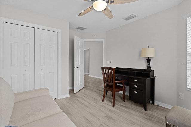 home office with ceiling fan and light wood-type flooring