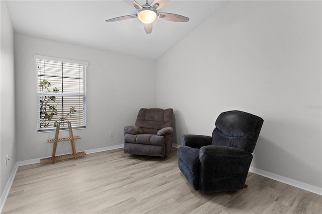 living area featuring vaulted ceiling, ceiling fan, and light hardwood / wood-style floors