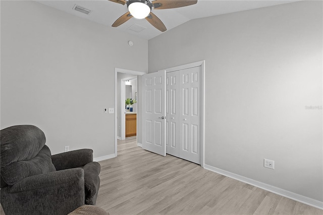 living area with vaulted ceiling, ceiling fan, and light hardwood / wood-style floors