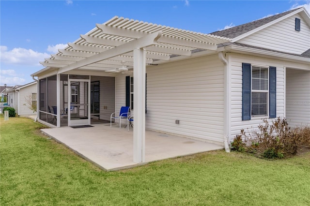 rear view of house with a pergola, a yard, a sunroom, and a patio area