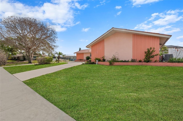 view of side of home featuring a lawn