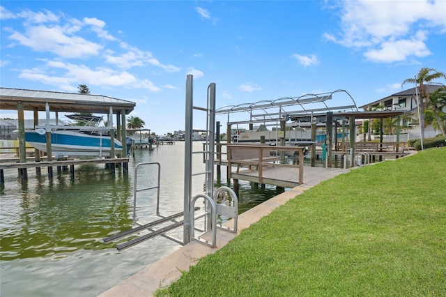 view of dock with a lawn and a water view