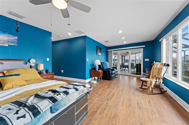 bedroom with ceiling fan, light wood-type flooring, a textured ceiling, and access to outside