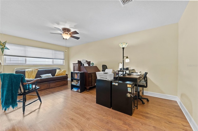 home office featuring light wood-type flooring and ceiling fan