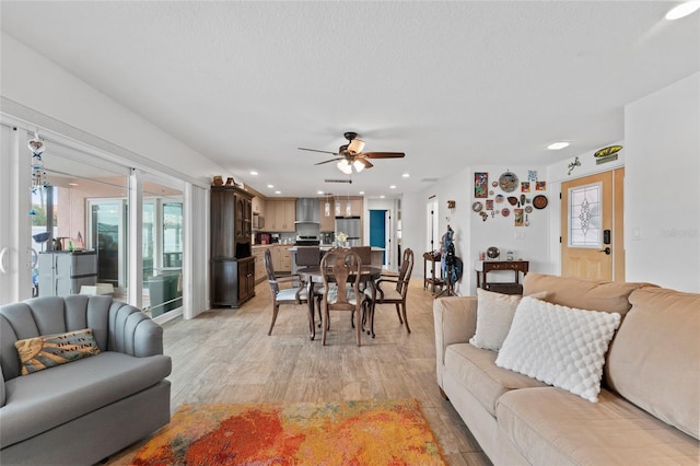 living room featuring light hardwood / wood-style floors and ceiling fan