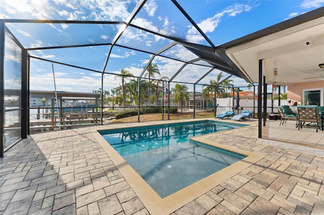 view of pool with a lanai, ceiling fan, and a patio