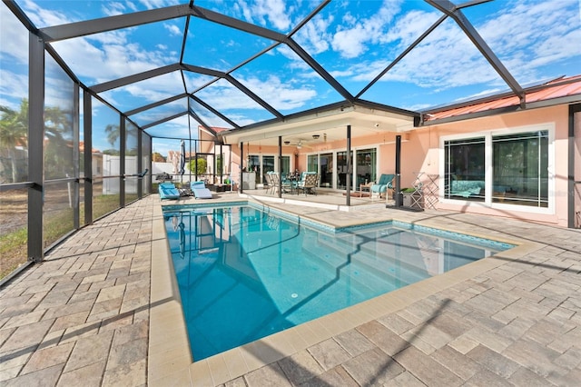 view of swimming pool featuring a lanai, a patio area, and ceiling fan