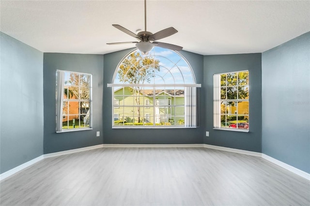 unfurnished room with hardwood / wood-style floors, ceiling fan, and lofted ceiling