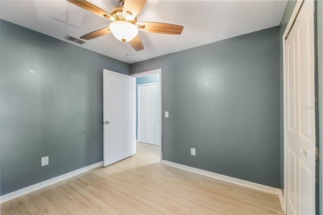 empty room featuring ceiling fan and light hardwood / wood-style floors