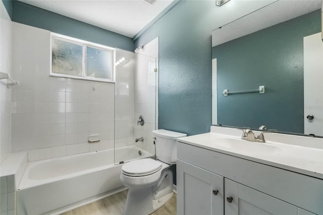 full bathroom with wood-type flooring, vanity, toilet, and tiled shower / bath