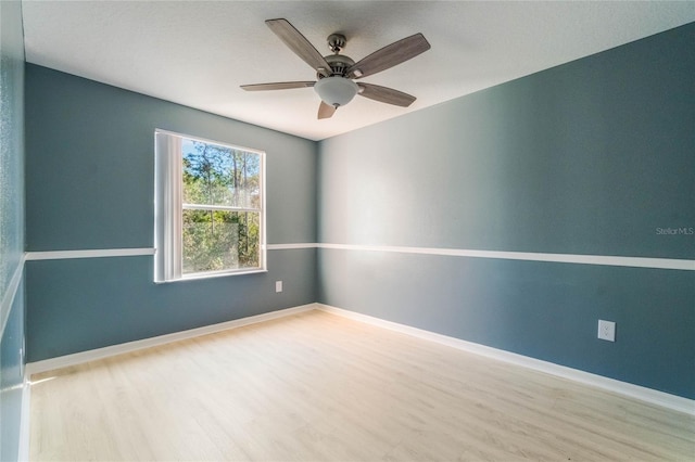 empty room with light hardwood / wood-style floors and ceiling fan