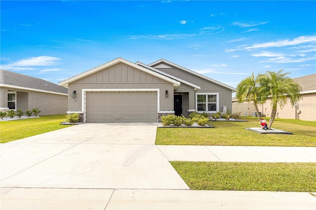 view of front of house featuring a garage and a front lawn