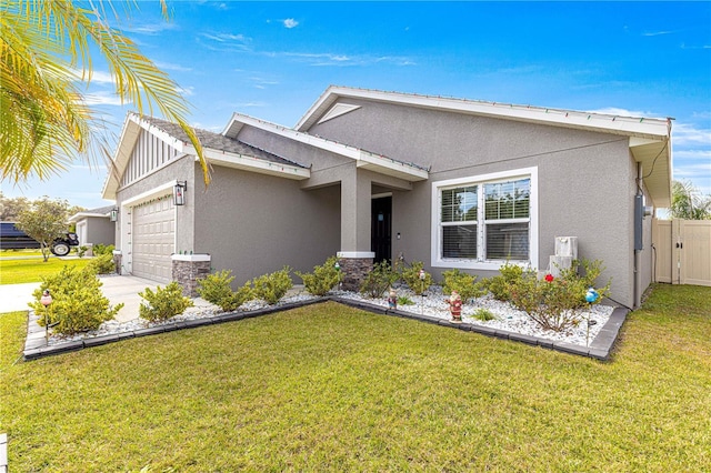 view of front of property featuring a front yard and a garage