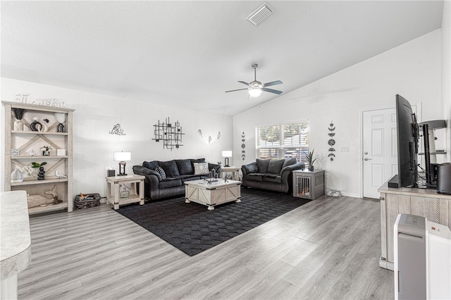 living room featuring ceiling fan, hardwood / wood-style floors, and lofted ceiling