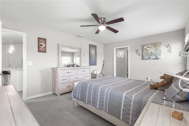 carpeted bedroom with connected bathroom and ceiling fan