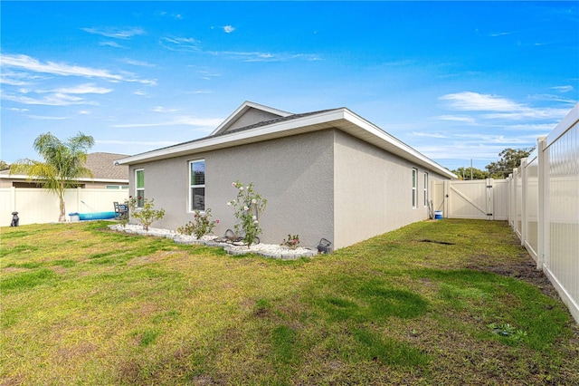 view of side of property featuring a yard