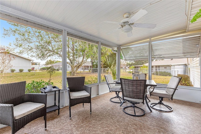 sunroom featuring ceiling fan