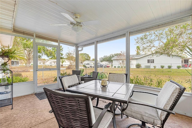 sunroom featuring ceiling fan and lofted ceiling