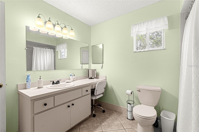 bathroom with tile patterned flooring, vanity, toilet, and a textured ceiling