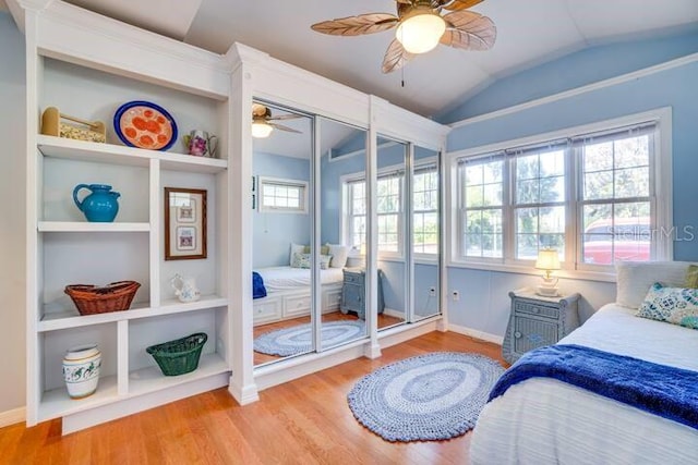 bedroom with multiple windows, a closet, ceiling fan, and light hardwood / wood-style floors