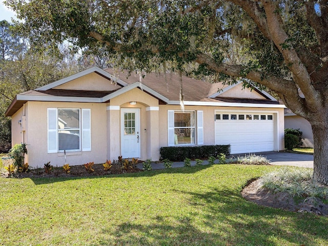 ranch-style house featuring a front yard and a garage