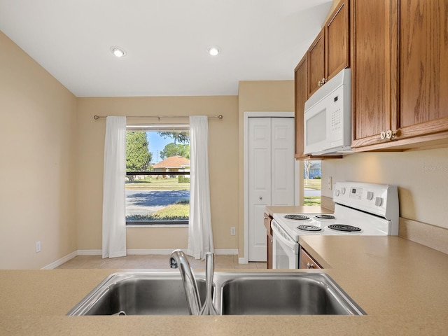 kitchen featuring sink and white appliances