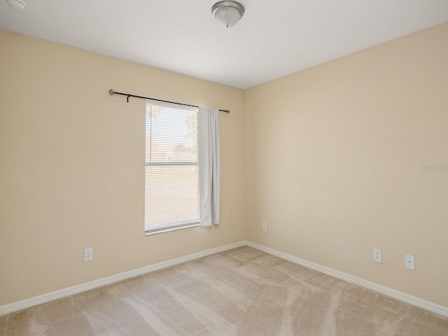 spare room with light colored carpet