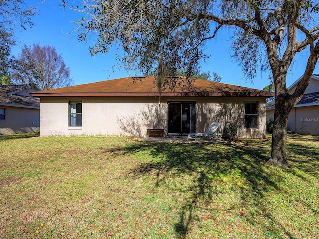 back of house with a yard