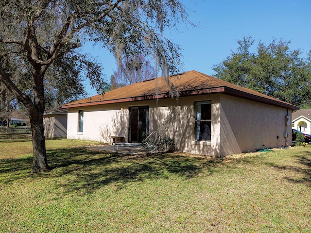 rear view of property with a yard