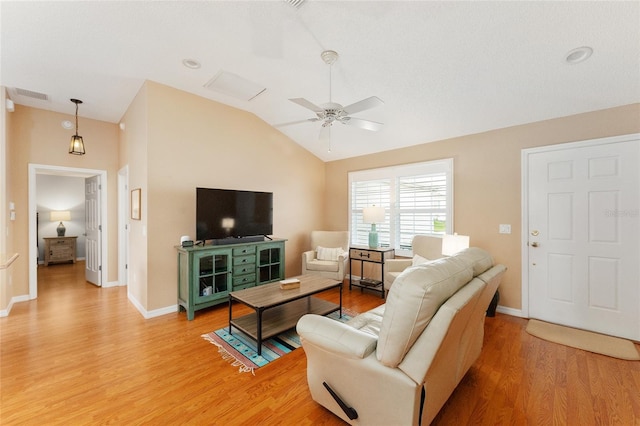 living room featuring ceiling fan, light hardwood / wood-style floors, and lofted ceiling