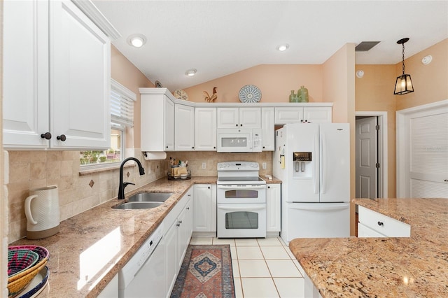 kitchen with white appliances, sink, hanging light fixtures, vaulted ceiling, and white cabinetry