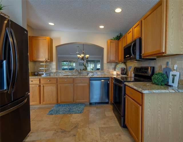 kitchen with sink, black refrigerator with ice dispenser, stainless steel dishwasher, decorative backsplash, and electric range