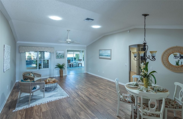 interior space featuring a textured ceiling, vaulted ceiling, hardwood / wood-style floors, crown molding, and ceiling fan with notable chandelier