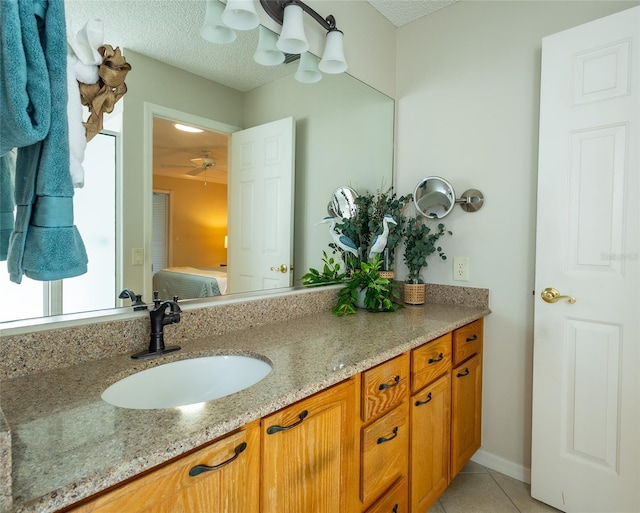 bathroom featuring ceiling fan, tile patterned floors, and vanity