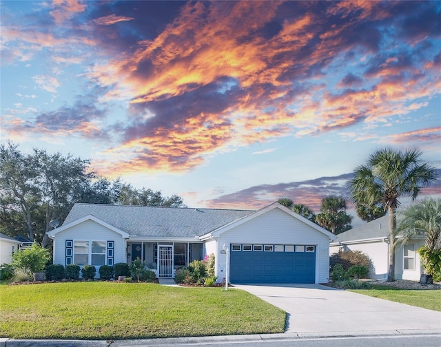 ranch-style house with a yard and a garage