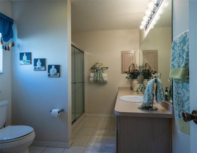 bathroom featuring toilet, a shower with door, vanity, and tile patterned floors