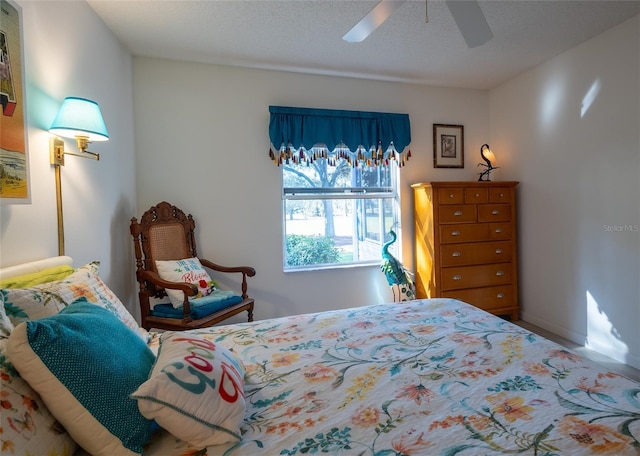 bedroom with a textured ceiling and ceiling fan